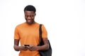 Happy young man looking at mobile phone against isolated white background Royalty Free Stock Photo