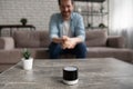 Happy young man looking at small digital portable assistant.