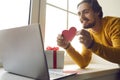 Happy young man in love showing Valentine card to his girlfriend during virtual date in quarantine Royalty Free Stock Photo