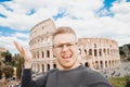 Happy young man making selfie Colosseum in Rome, Italy. Concept travel outrage museum queue Royalty Free Stock Photo