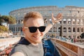 Happy young man making selfie in sunglasses Colosseum in Rome, Italy. Concept travel trip Royalty Free Stock Photo