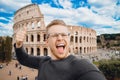 Happy young man making selfie thumb up sign in front of Colosseum in Rome, Italy. Concept travel trip Royalty Free Stock Photo