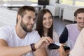 Happy young man meeting with cheerful friends in cafe Royalty Free Stock Photo