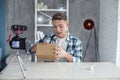 Happy young man opening his box