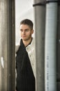 Happy young man outdoor seen between two pillars Royalty Free Stock Photo