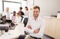 Happy young man over creative team in office Royalty Free Stock Photo