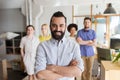 Happy young man over creative team in office Royalty Free Stock Photo