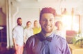 Happy young man over creative team in office Royalty Free Stock Photo