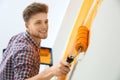 Happy young man painting wall. Home repair Royalty Free Stock Photo