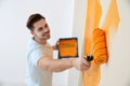 Happy young man painting wall. Home repair Royalty Free Stock Photo