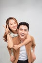 Happy young man piggybacking his girlfriend, close up photo Royalty Free Stock Photo