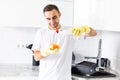 Happy young man standing and washing dishes on the kitchen Royalty Free Stock Photo