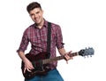 Happy young man playing his electric guitar and smiling Royalty Free Stock Photo