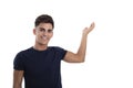 Happy young man pointing with his hand in a photo studio