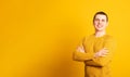 Happy young man. Portrait of handsome young man in casual sweater keeping arms crossed and smiling while standing. Royalty Free Stock Photo