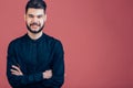 Happy young man. Portrait of handsome young man keeping arms crossed and smiling Royalty Free Stock Photo