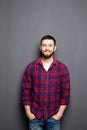 Happy young man. Portrait of handsome young man in casual shirt with hands in pockets and smiling Royalty Free Stock Photo