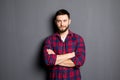 Happy young man. Portrait of handsome young man in casual shirt keeping arms crossed and smiling Royalty Free Stock Photo