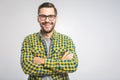 Happy young man. Portrait of handsome young man in casual shirt keeping arms crossed and smiling while standing Royalty Free Stock Photo