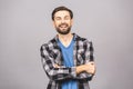 Happy young man. Portrait of handsome young man in casual shirt keeping arms crossed and smiling while standing Royalty Free Stock Photo