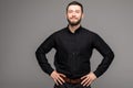 Happy young man. Portrait of handsome young man in casual shirt smiling while standing against grey background Royalty Free Stock Photo