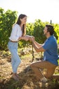 Happy young man proposing his girlfriend at vineyard Royalty Free Stock Photo