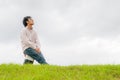 Happy young man rest on the grass field Royalty Free Stock Photo