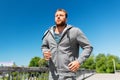 Happy young man running across city bridge Royalty Free Stock Photo