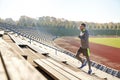 Happy young man running upstairs on stadium Royalty Free Stock Photo