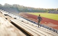 Happy young man running upstairs on stadium Royalty Free Stock Photo