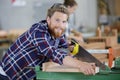 happy young man sawing wood saw Royalty Free Stock Photo