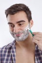 Happy young man shaving Royalty Free Stock Photo