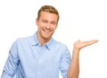 Happy young man showing empty copyspace on white background