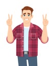 Happy young man showing peace sign. Stylish person making victory, V, winner or two gesture with fingers. Trendy male character. Royalty Free Stock Photo