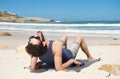 Happy young man sitting alone at the beach Royalty Free Stock Photo