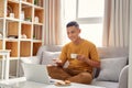 Happy young Man sitting in sofa and using laptop Royalty Free Stock Photo