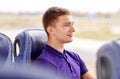 Happy young man sitting in travel bus or train Royalty Free Stock Photo
