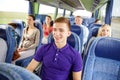 Happy young man sitting in travel bus or train Royalty Free Stock Photo