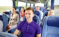 Happy young man sitting in travel bus or train Royalty Free Stock Photo