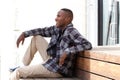 Happy young man sitting on a wooden bench Royalty Free Stock Photo