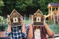 Happy young man and small sister with bug hotel spending time outdoors in backyard, playing. Royalty Free Stock Photo