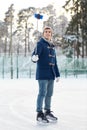 Happy young man with smartphone on ice rink Royalty Free Stock Photo