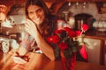 Happy young man with smartphone and roses.