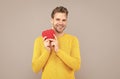 Happy young man smile holding Valentines heart grey background, love