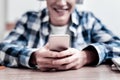 Happy young man smiling and feeling satisfied with his modern device Royalty Free Stock Photo