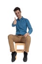 Happy young man smiling and making thumbs up sign Royalty Free Stock Photo