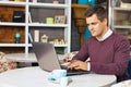 Happy young man smiling and works on his laptop Royalty Free Stock Photo