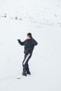 Happy young man with snowboard enjoying sunny weather in snowy mountains. Winter sport and recreation, leasure outdoor activities Royalty Free Stock Photo