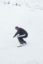 Happy young man with snowboard enjoying sunny weather in snowy mountains. Winter sport and recreation, leasure outdoor activities Royalty Free Stock Photo