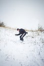 Happy young man with snowboard enjoying sunny weather in snowy mountains. Winter sport and recreation, leasure outdoor activities Royalty Free Stock Photo